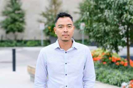 Man in front of a downtown plaza
