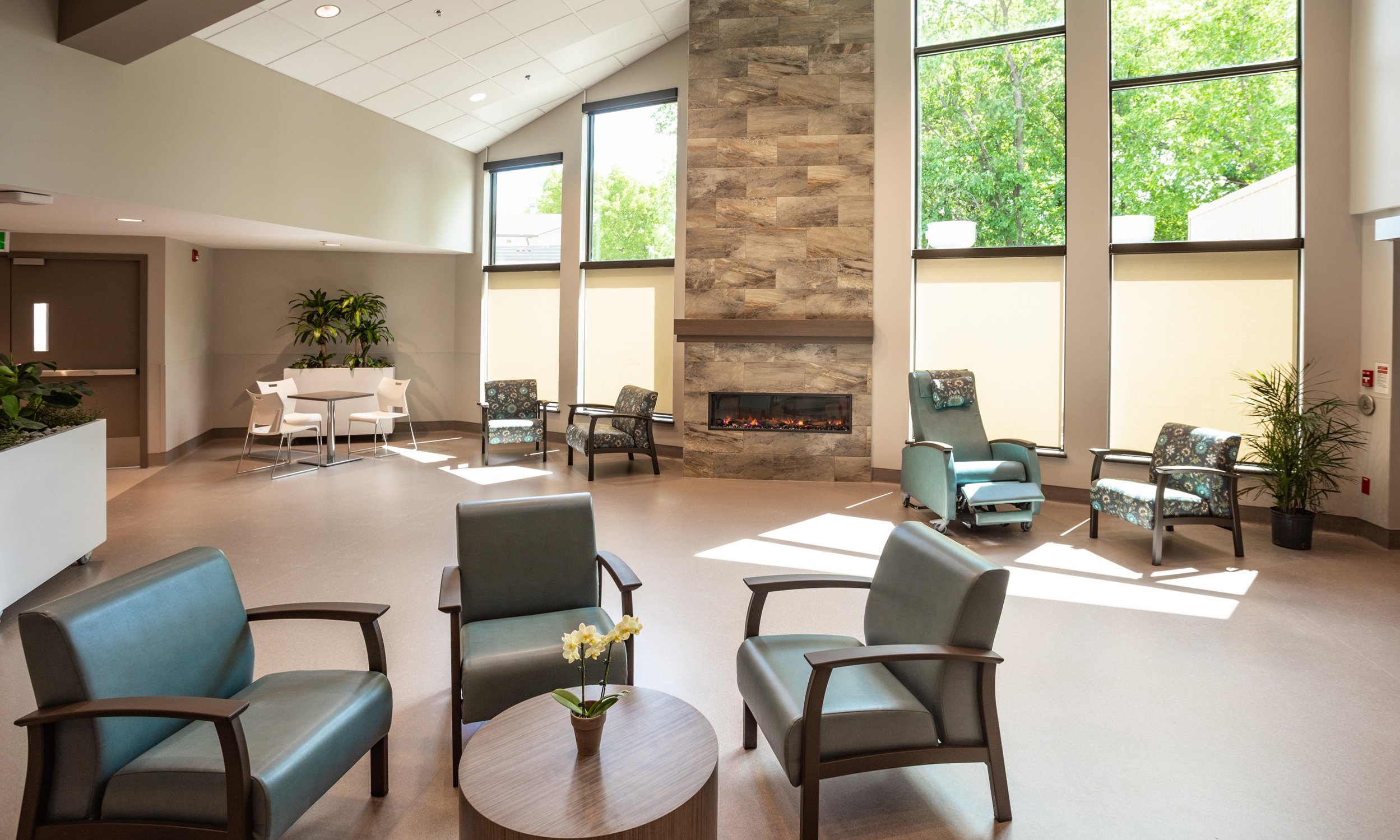 Brightly lit room with seating area and fireplace