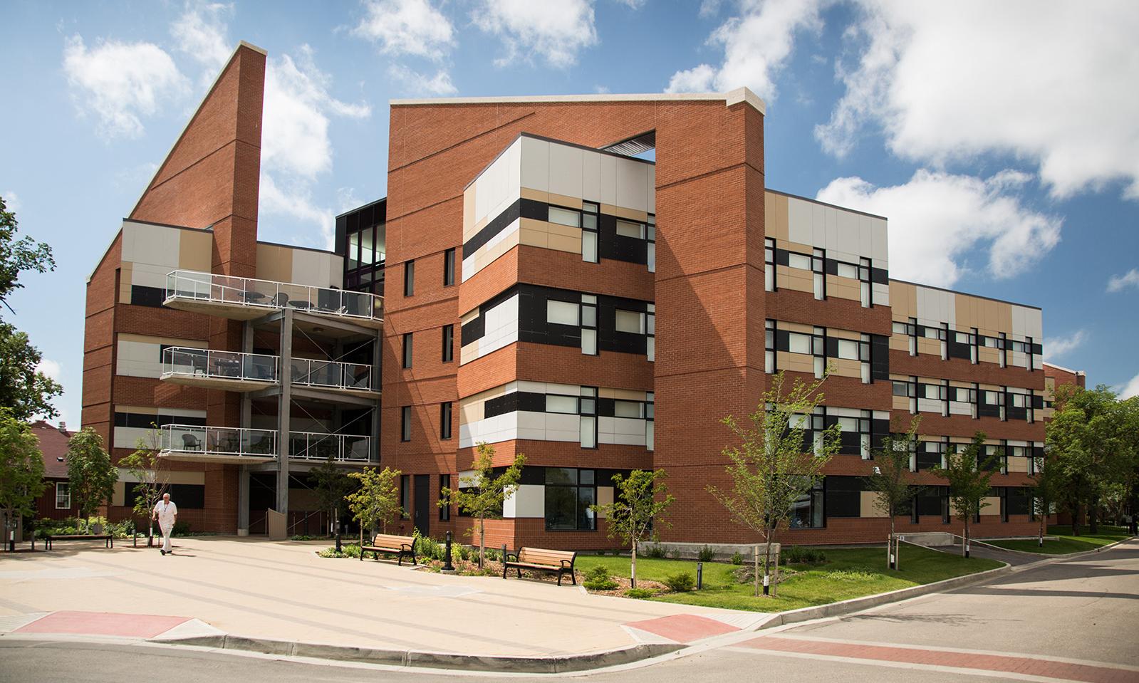 RCMP Fort Dufferin Cadet Dorm. Exterior of the dorm in its entirety including the front patio area and street.